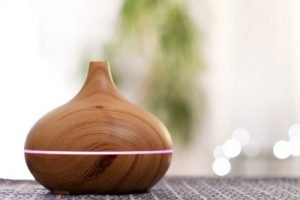 wood essential oil diffuser with pink light and steam